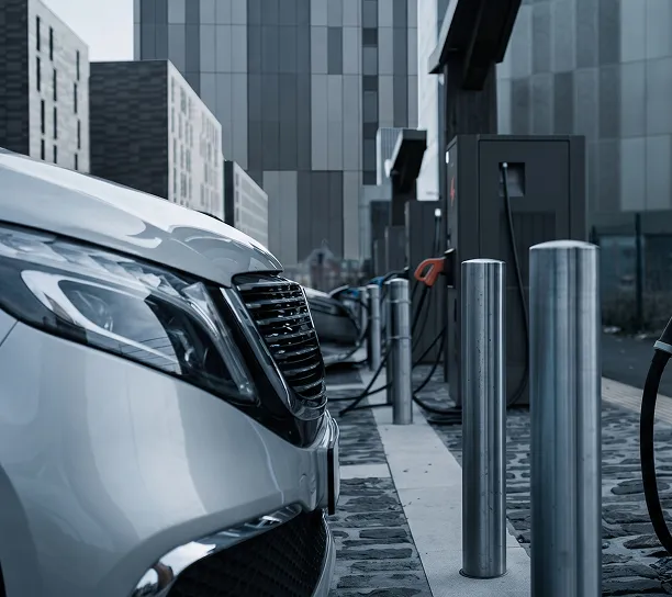 An electric vehicle charging outside an urban building
